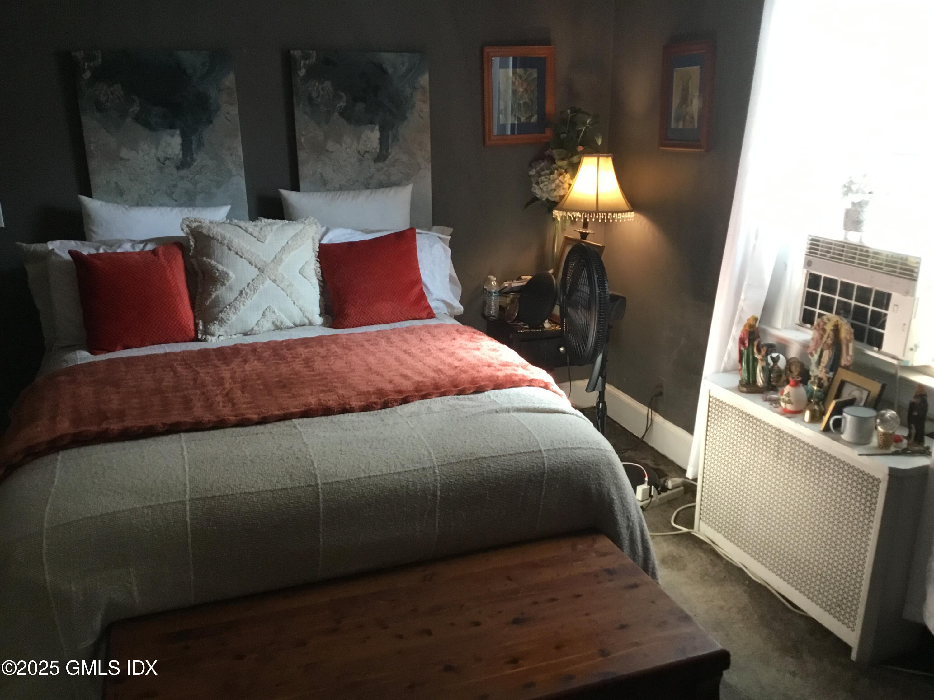 14 Sherman Avenue Greenwich, CT 06830 - Photo 24 of 27 a bedroom with a bed and a mirror