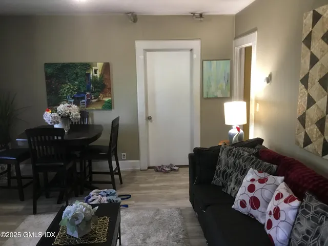 a living room with furniture and a potted plant