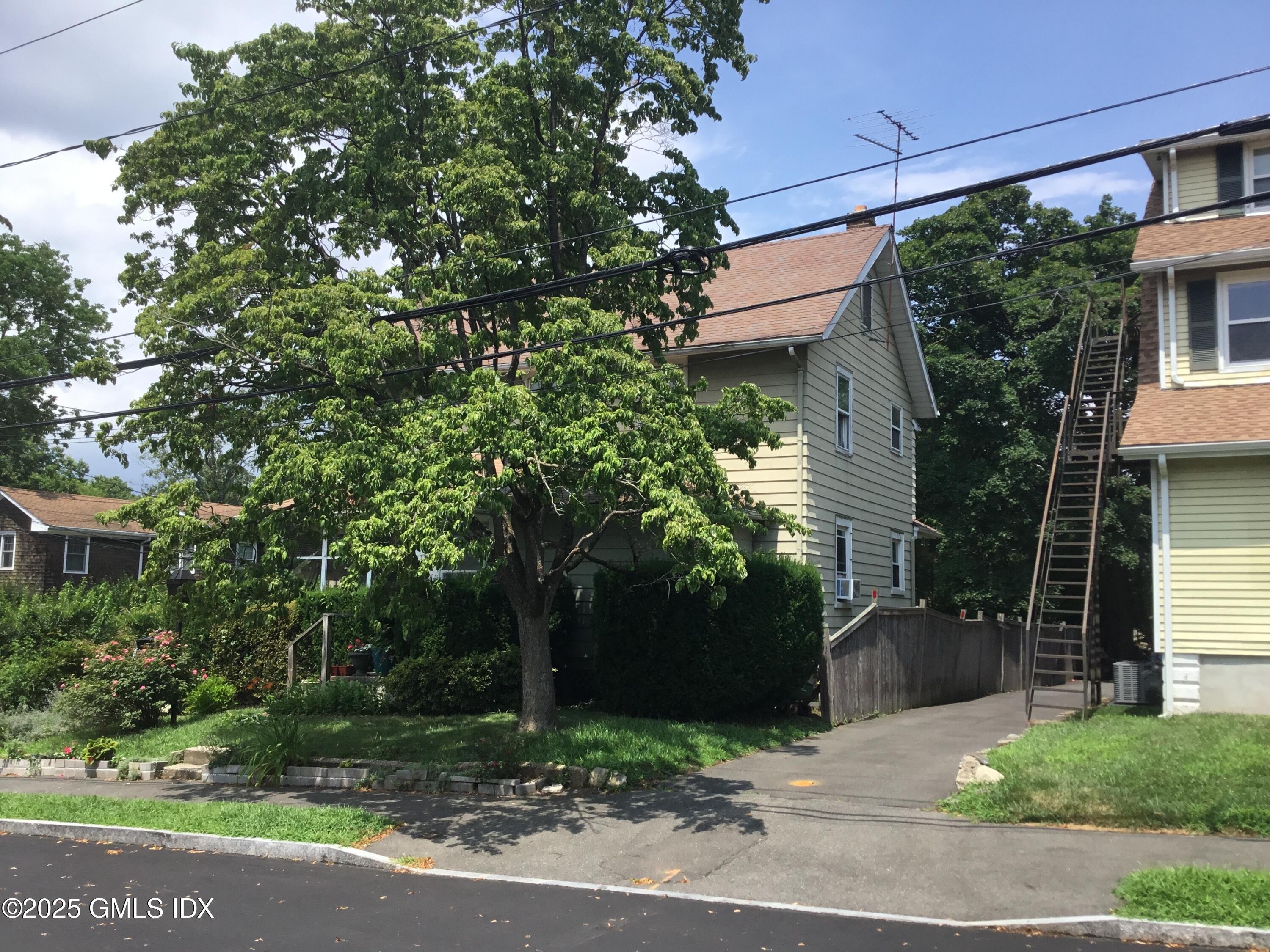 14 Sherman Avenue Greenwich, CT 06830 - Photo 3 of 27 a house with a tree in front of it