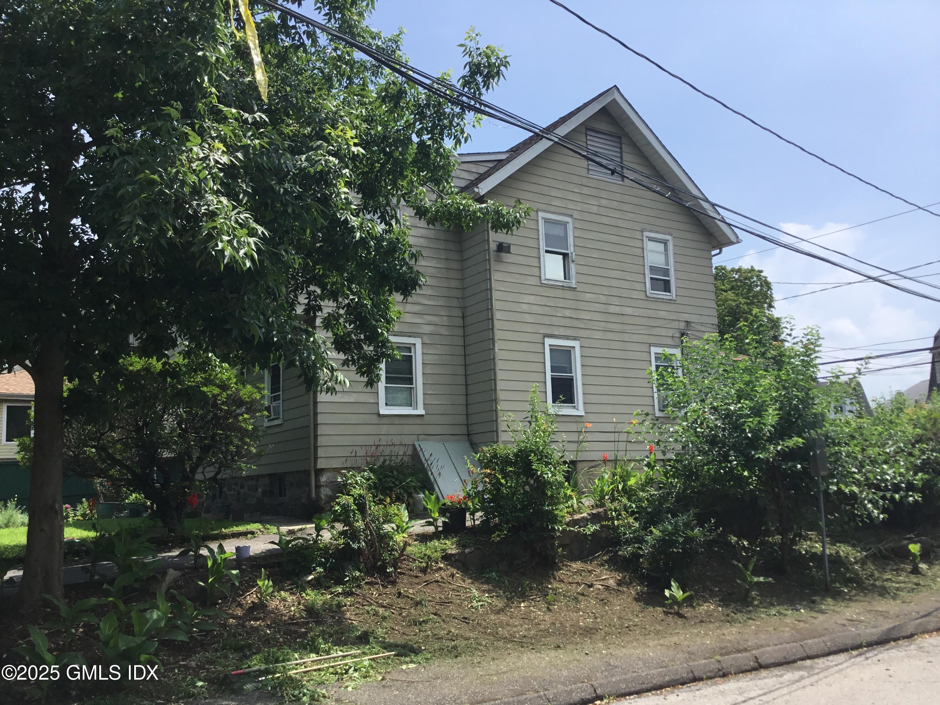 14 Sherman Avenue Greenwich, CT 06830 - Photo 6 of 27 a front view of a house with garden