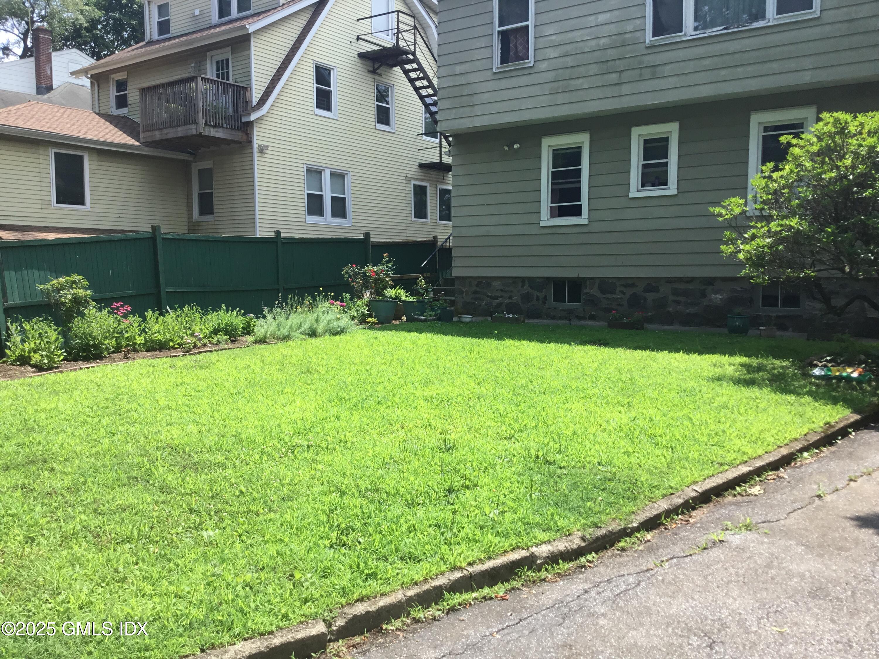 14 Sherman Avenue Greenwich, CT 06830 - Photo 8 of 27 a front view of a house with a yard