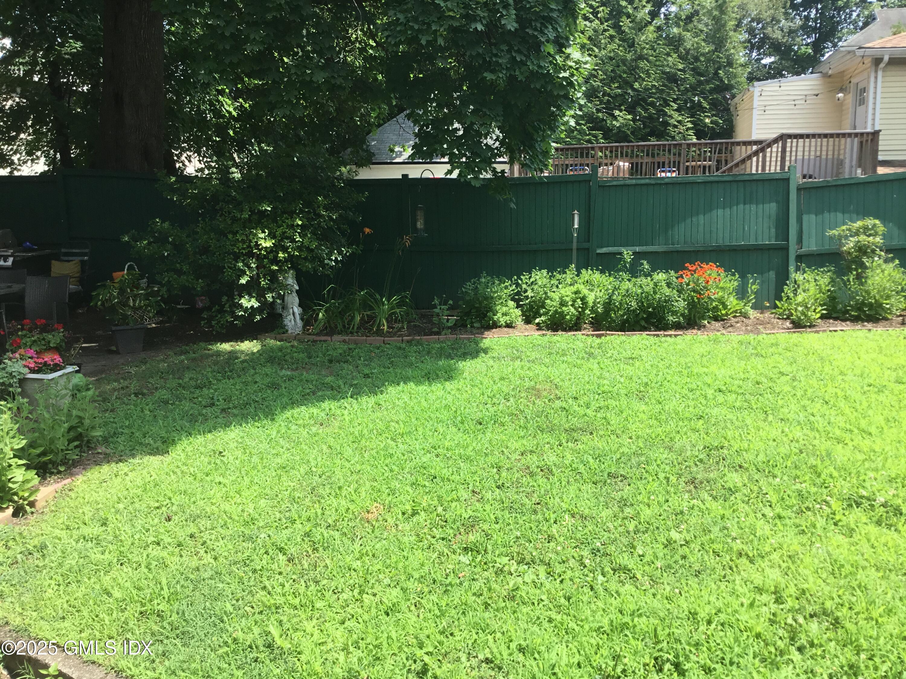 14 Sherman Avenue Greenwich, CT 06830 - Photo 9 of 27 a view of a garden with a tree in the background