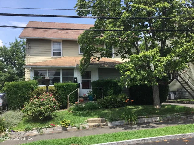 a front view of house with a yard