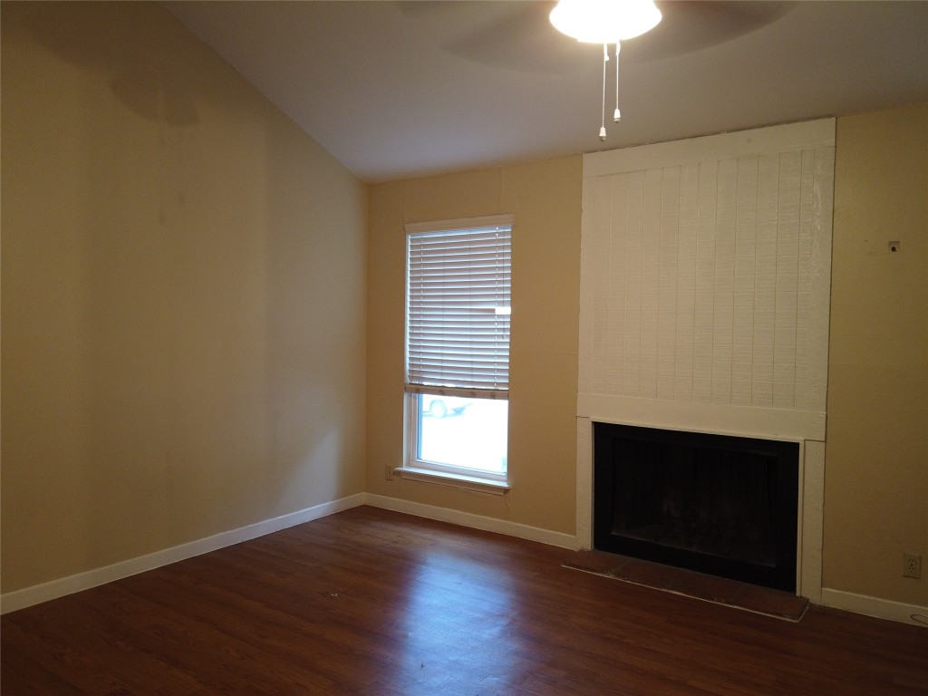 1000 West 26th Street, Unit 209 Austin, TX 78705 - Photo 14 of 20 a view of an empty room with wooden floor and a window