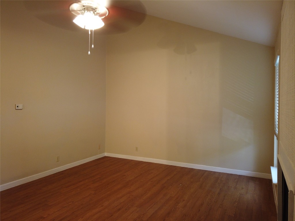 1000 West 26th Street, Unit 209 Austin, TX 78705 - Photo 2 of 20 a view of a room with wooden floor and a fan