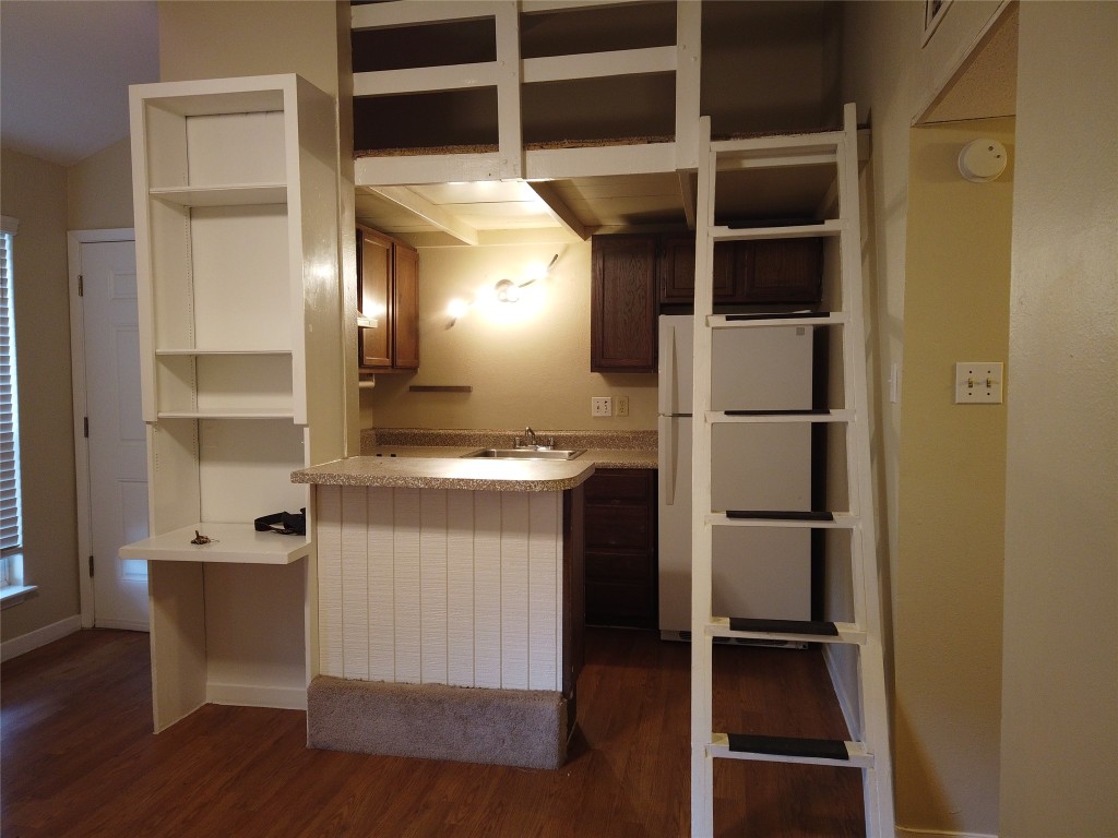 1000 West 26th Street, Unit 209 Austin, TX 78705 - Photo 5 of 20 a view of a walk in closet and wooden shelves