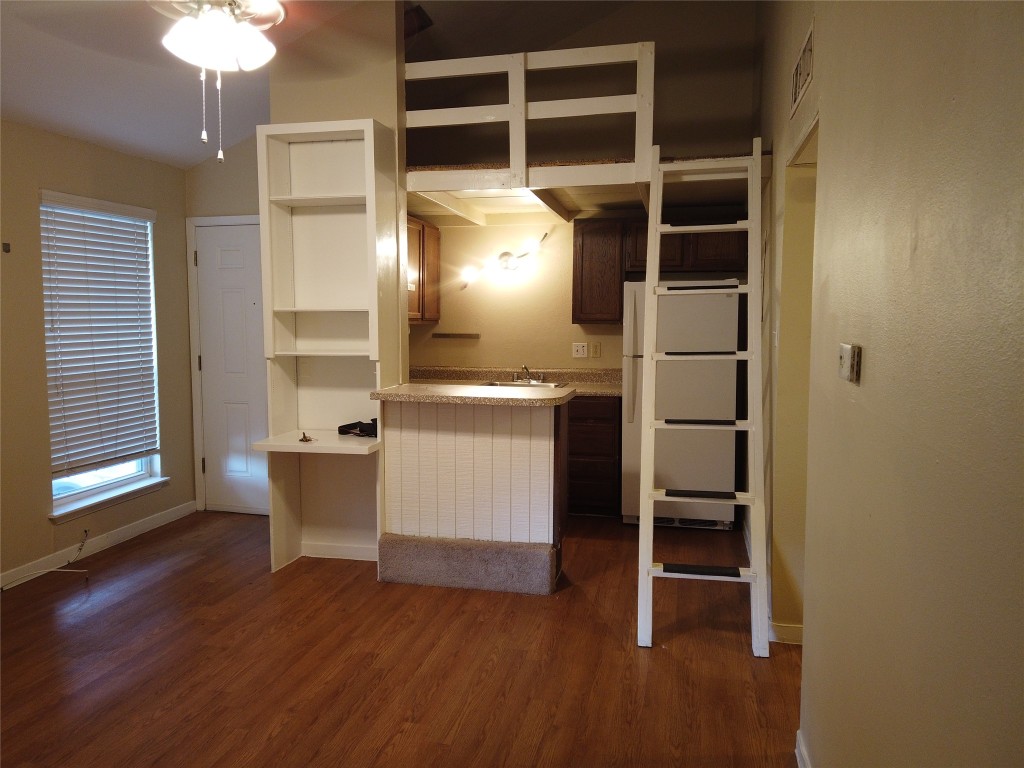 1000 West 26th Street, Unit 209 Austin, TX 78705 - Photo 6 of 20 a view of a kitchen with furniture and wooden floor