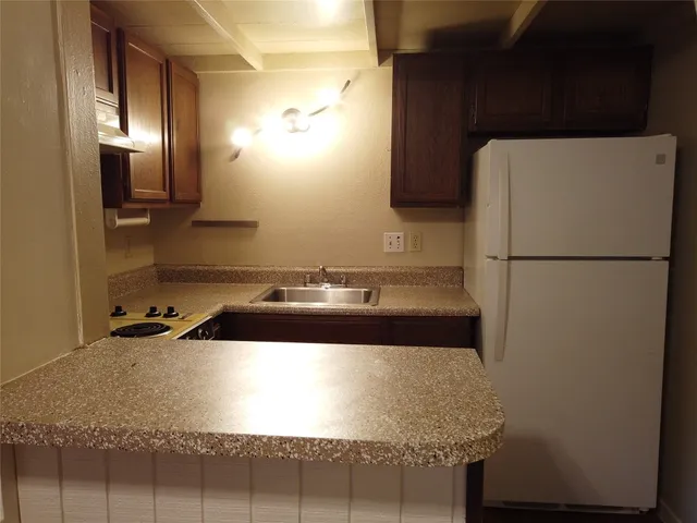 a kitchen with a sink a stove and cabinets
