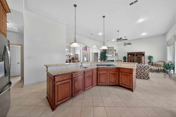 a kitchen with stainless steel appliances granite countertop a sink a stove and a wooden floors