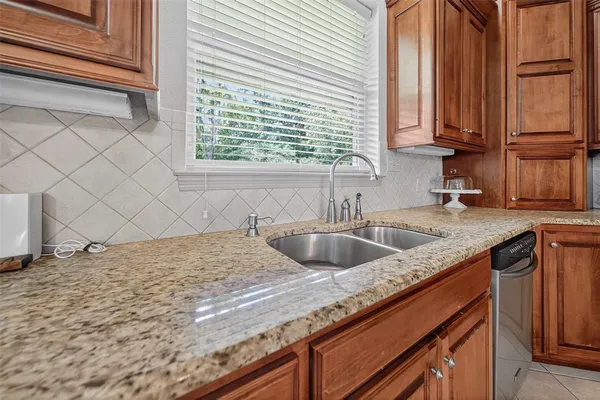 a kitchen with a sink cabinets and window
