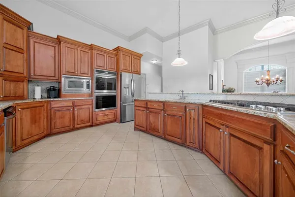 a large kitchen with stainless steel appliances and cabinets