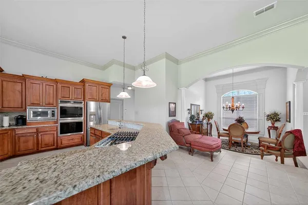 a large kitchen with a large counter space and stainless steel appliances