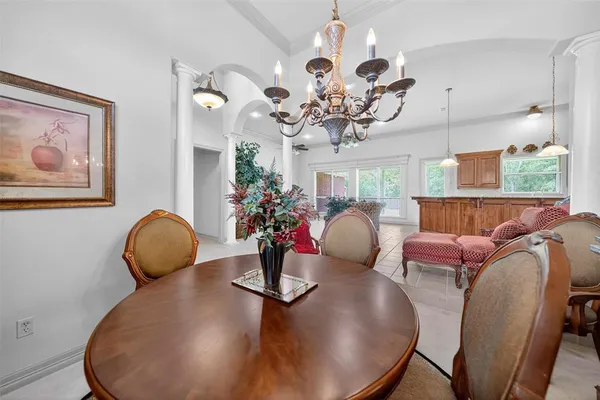 a view of a dining room with furniture a chandelier and wooden floor