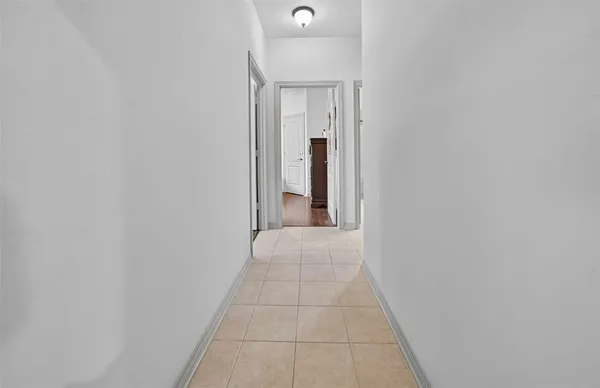 a view of a hallway with wooden floor and closet