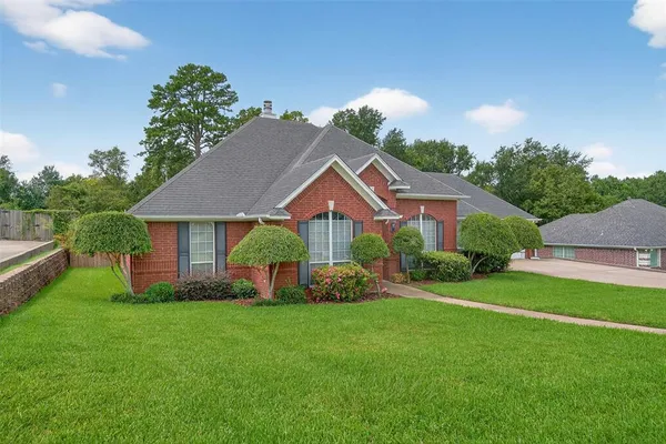 a front view of a house with garden