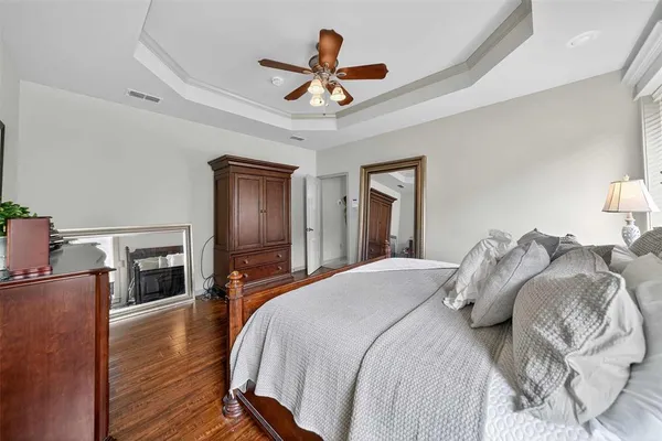 a bedroom with a bed and a ceiling fan