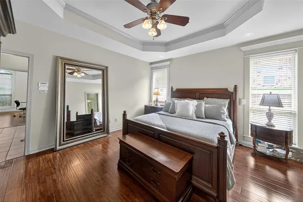 a bedroom with a bed and a chandelier