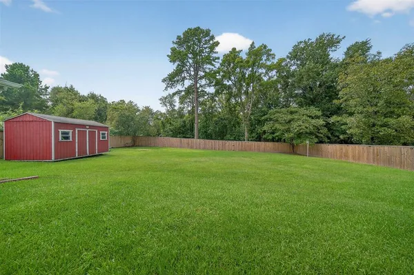 a view of garden with trees in the background