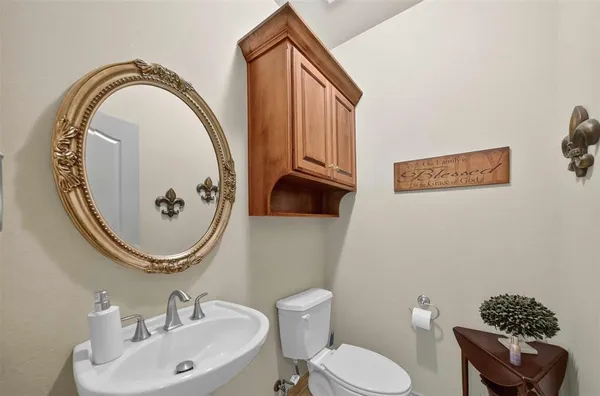 a bathroom with a toilet a sink and a mirror