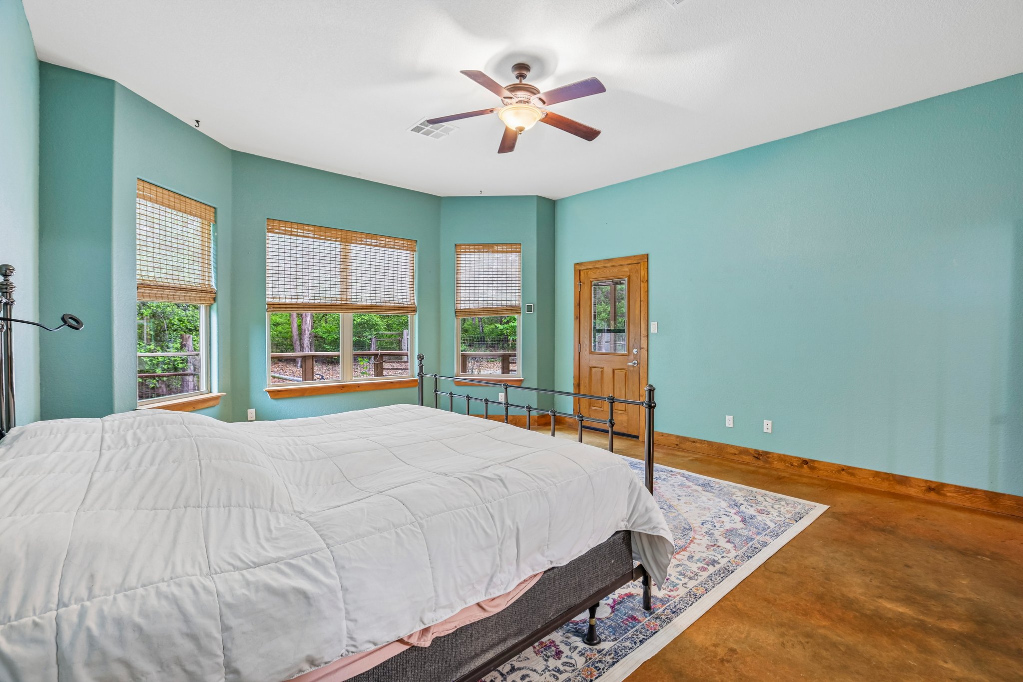 267 Corral Road Smithville, TX 78957 - Photo 28 of 40 Spacious room featuring multiple windows with natural wood blinds, a ceiling fan, and wood-finish flooring