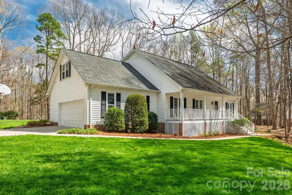 a view of a house with a yard and sitting area
