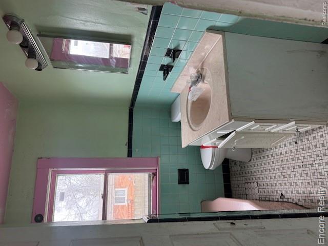 19300 Berg Road Detroit, MI 48219 - Photo 9 of 28 Full bath featuring vanity, wainscoting, and tile walls