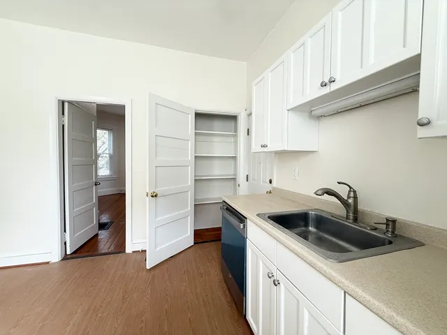 a kitchen with stainless steel appliances granite countertop a sink and a stove