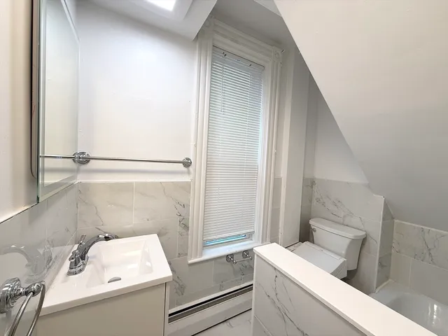 a bathroom with a sink toilet and tub