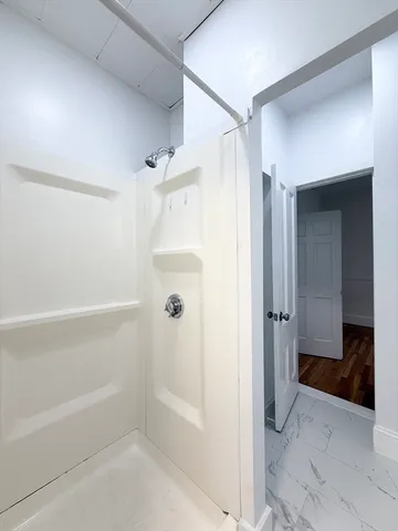 a bathroom with a bathtub and shower