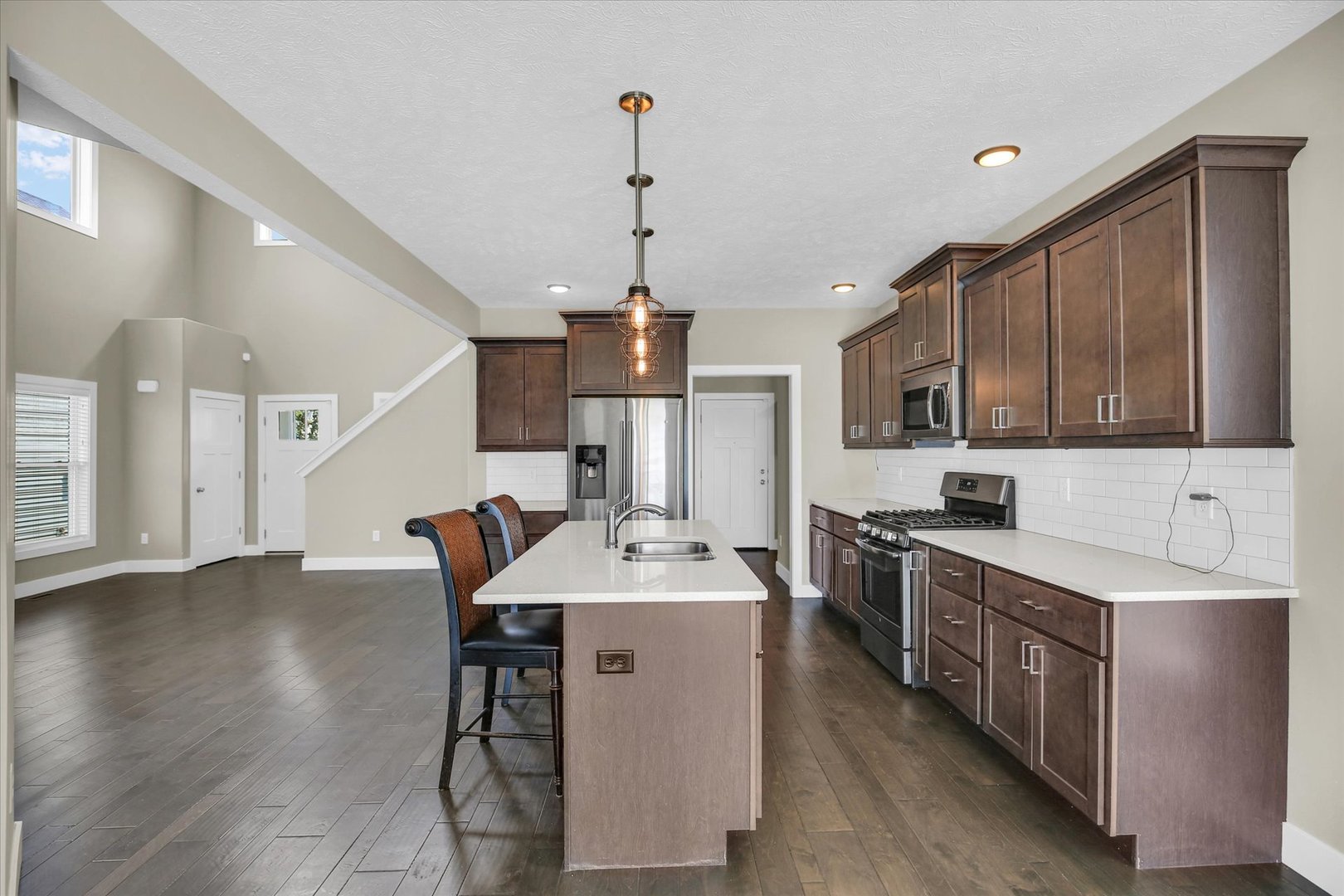 5008 Emmas Way Champaign, IL 61822 - Photo 13 of 53 a kitchen with stainless steel appliances a sink stove cabinets and wooden floor