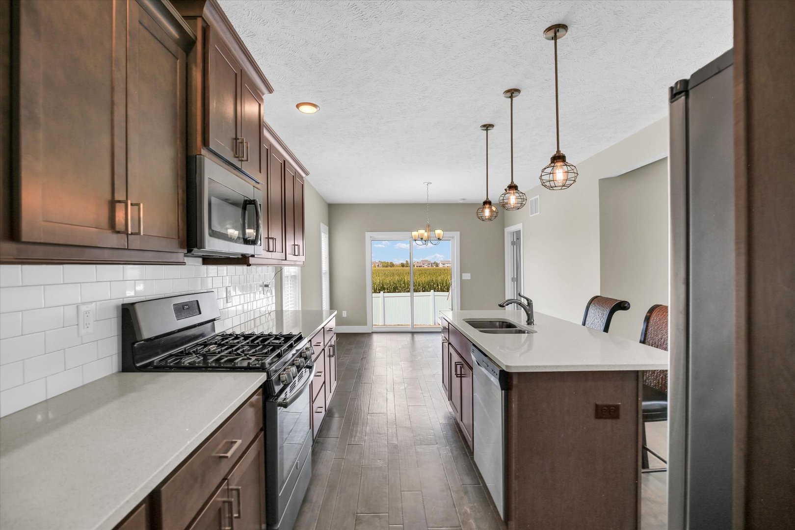 5008 Emmas Way Champaign, IL 61822 - Photo 15 of 53 a kitchen with a sink stove and cabinets