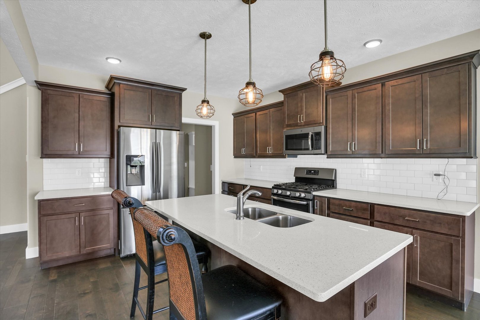 5008 Emmas Way Champaign, IL 61822 - Photo 17 of 53 a kitchen that has a cabinets a sink and chairs