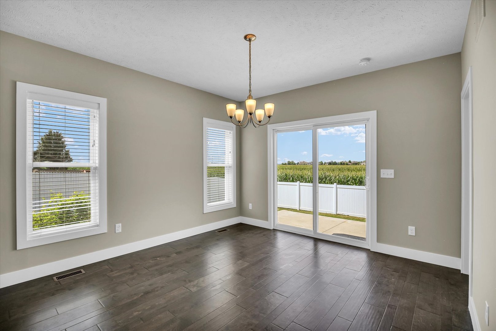 5008 Emmas Way Champaign, IL 61822 - Photo 18 of 53 a view of an empty room with wooden floor and a window