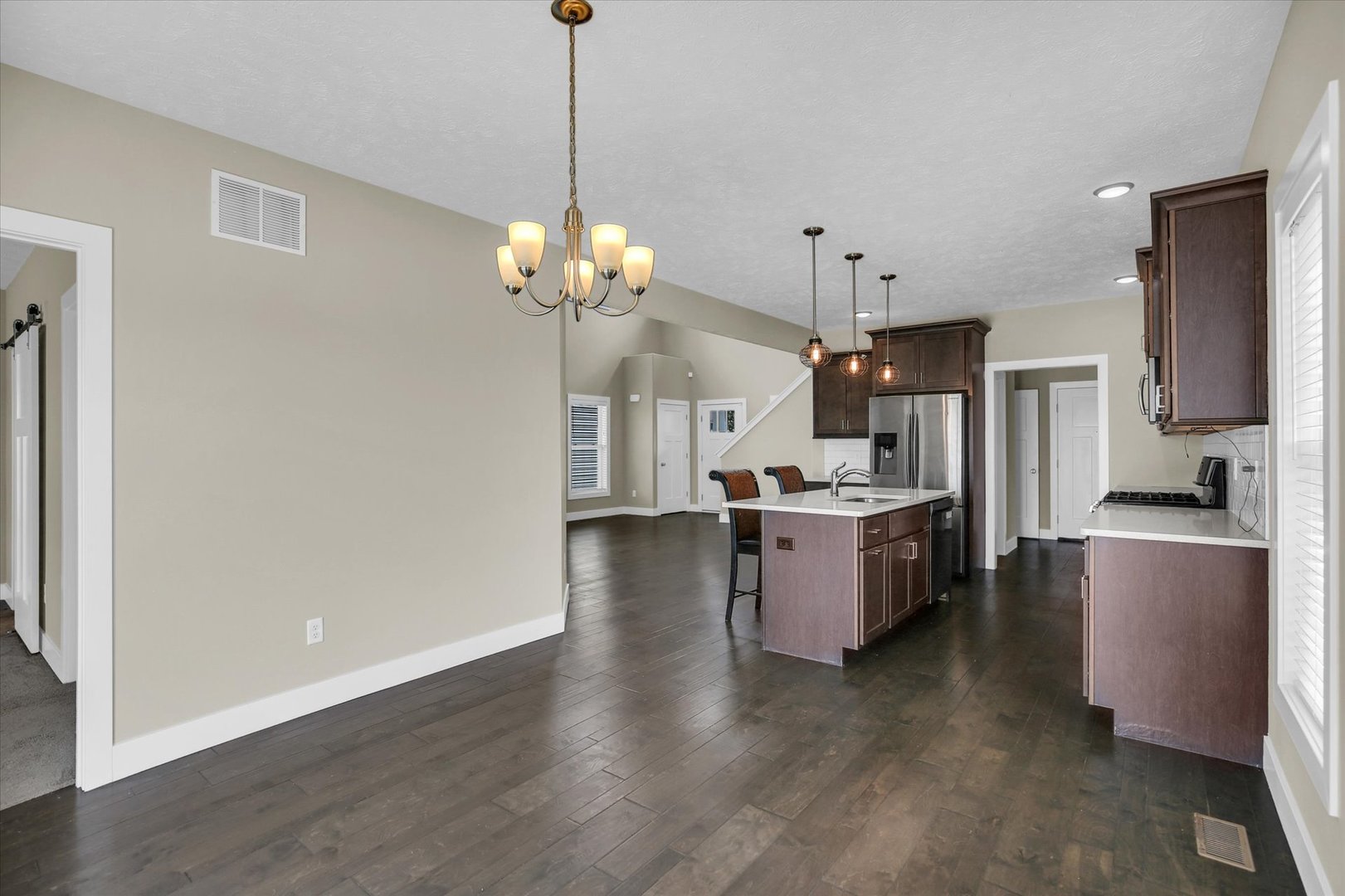 5008 Emmas Way Champaign, IL 61822 - Photo 19 of 53 a large kitchen with a center island wooden floor and stainless steel appliances