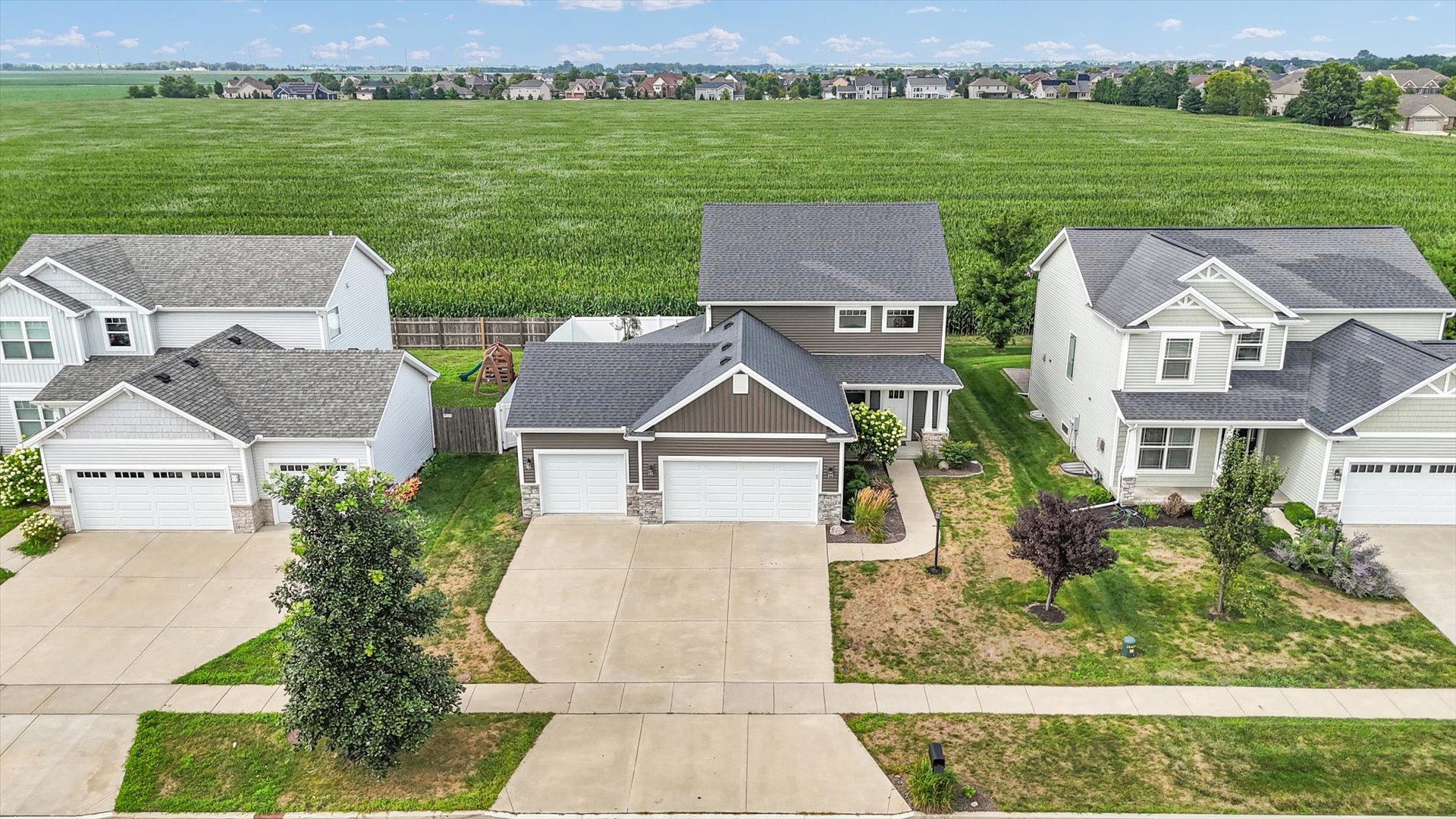 5008 Emmas Way Champaign, IL 61822 - Photo 3 of 53 an aerial view of a house with a garden and a lake view