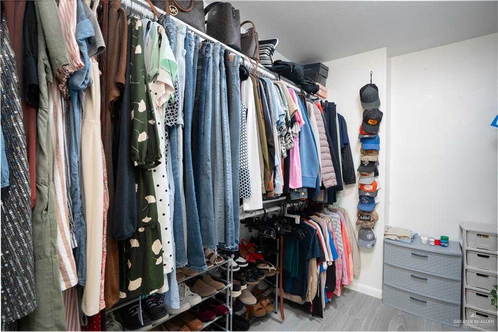 32516 El Preseno Road San Benito, TX 78586 - Photo 15 of 45 a view of walk in closet with clothes