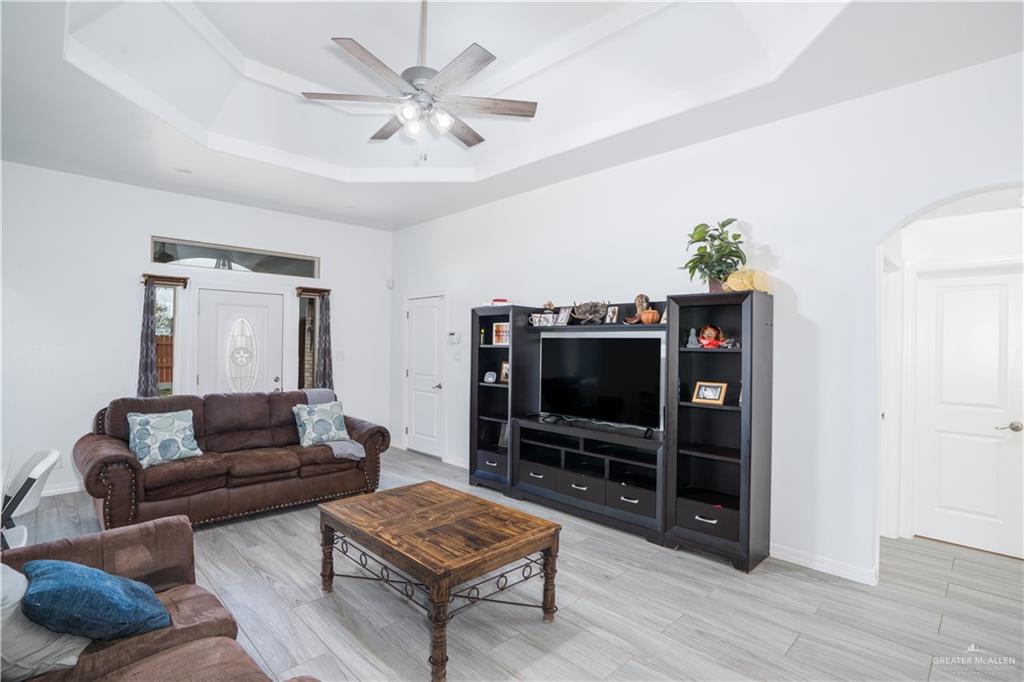 32516 El Preseno Road San Benito, TX 78586 - Photo 24 of 45 a living room with furniture and a flat screen tv