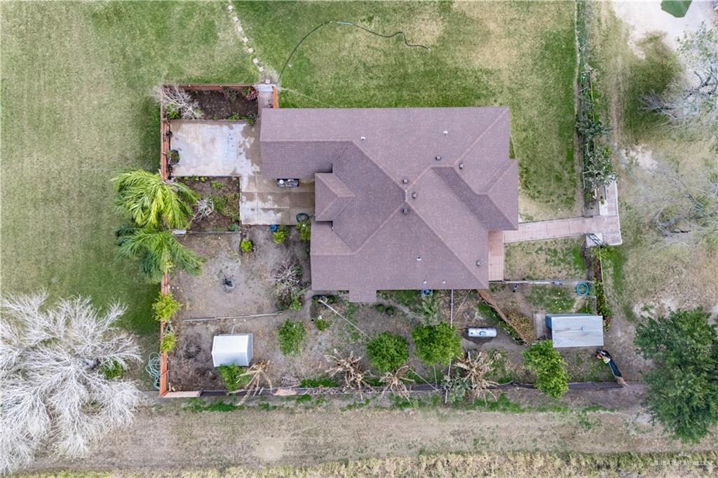 32516 El Preseno Road San Benito, TX 78586 - Photo 33 of 45 an aerial view of a house with a yard and trees