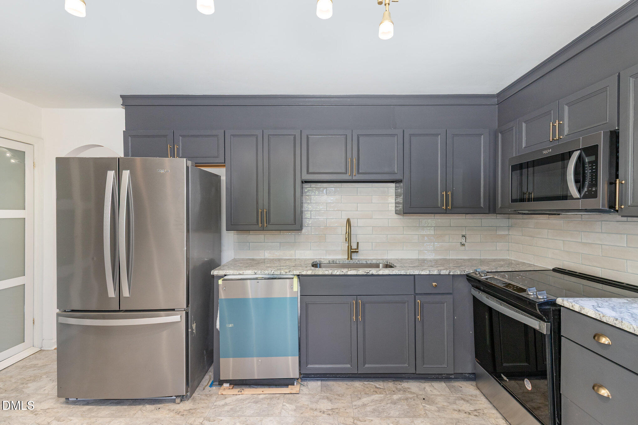 608 Dennis Avenue Raleigh, NC 27604 - Photo 10 of 30 a kitchen with stainless steel appliances granite countertop a refrigerator stove top oven and sink