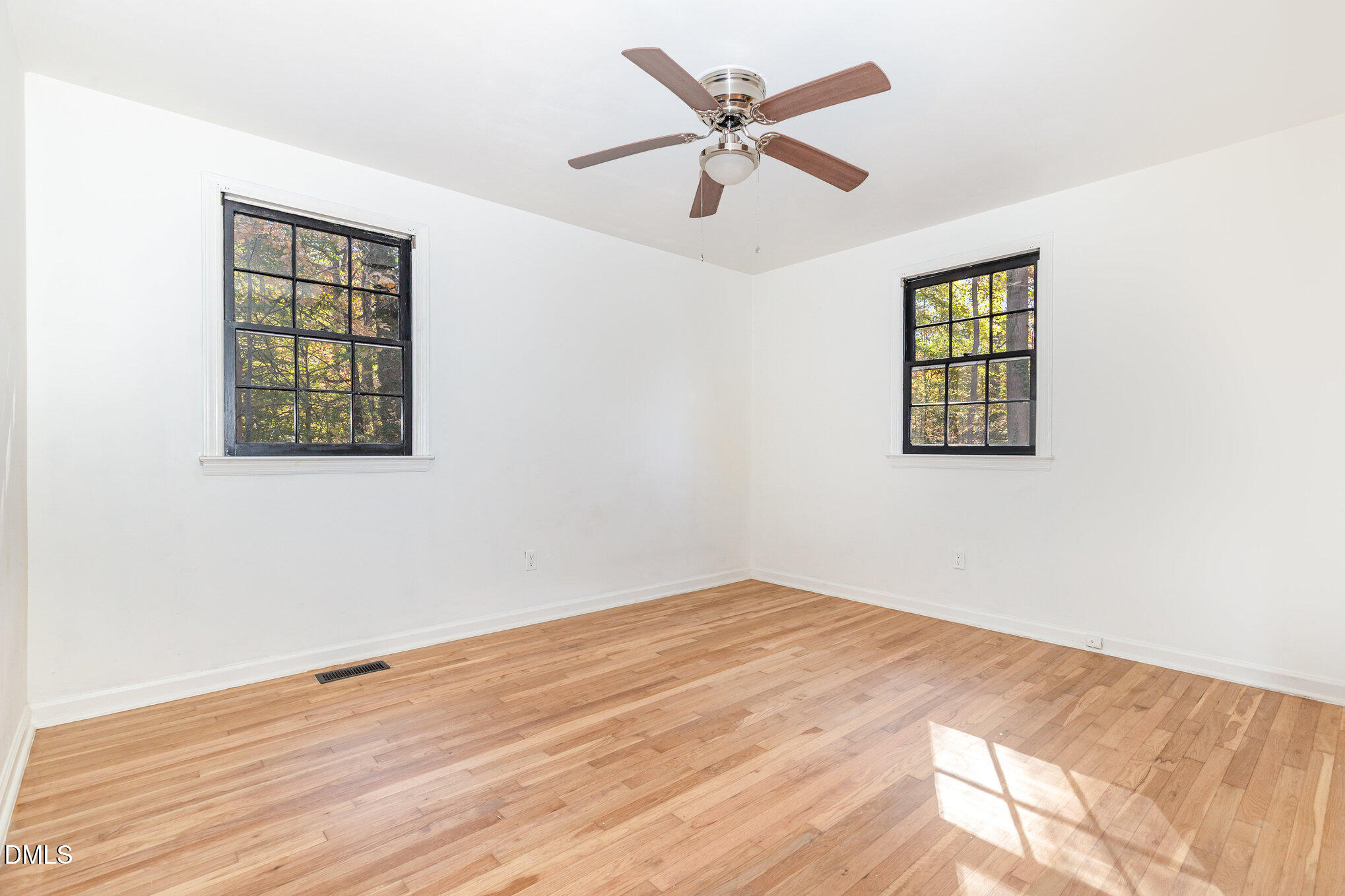 608 Dennis Avenue Raleigh, NC 27604 - Photo 12 of 30 a view of an empty room with wooden floor and a window