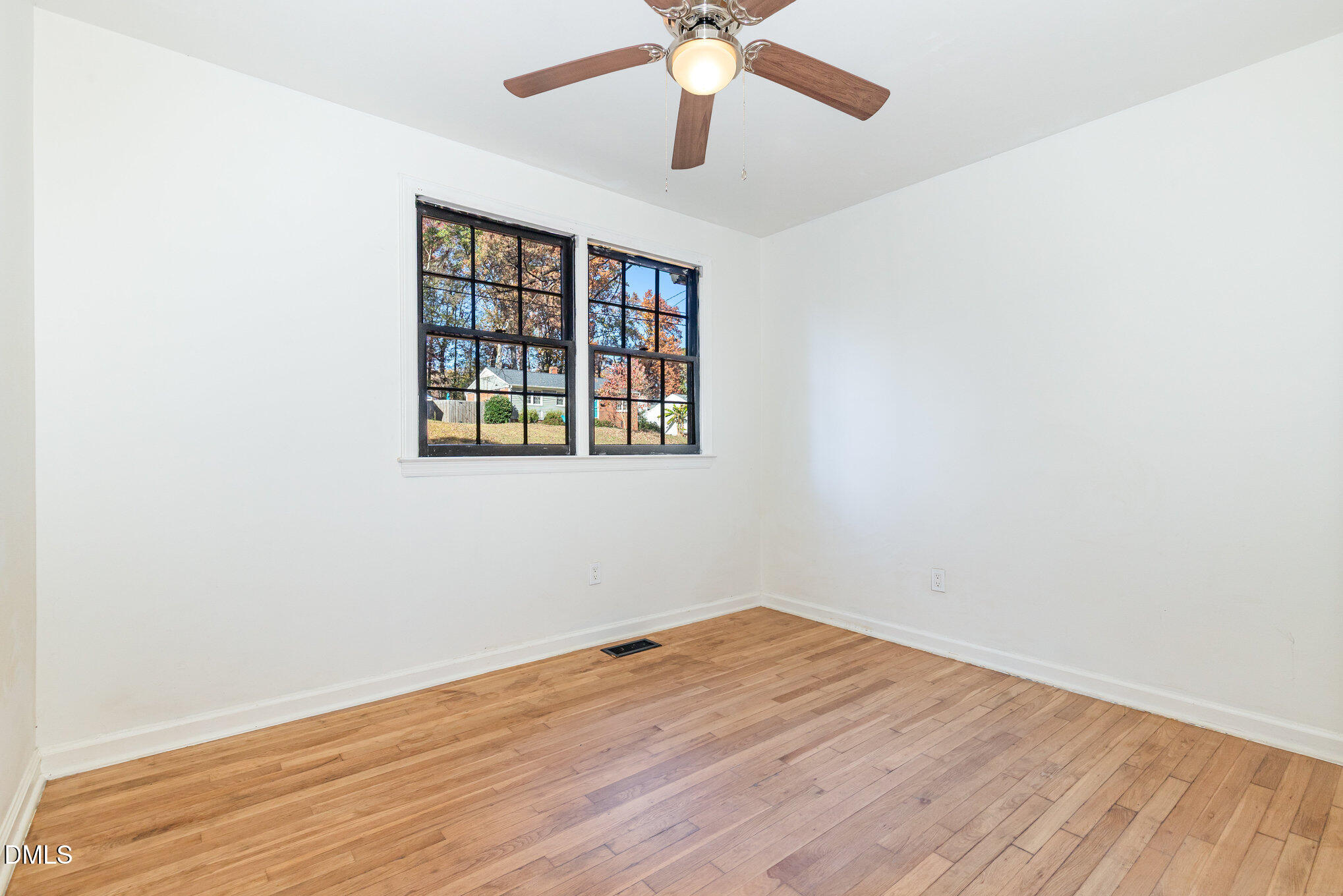 608 Dennis Avenue Raleigh, NC 27604 - Photo 14 of 30 an empty room with a window and a ceiling fan