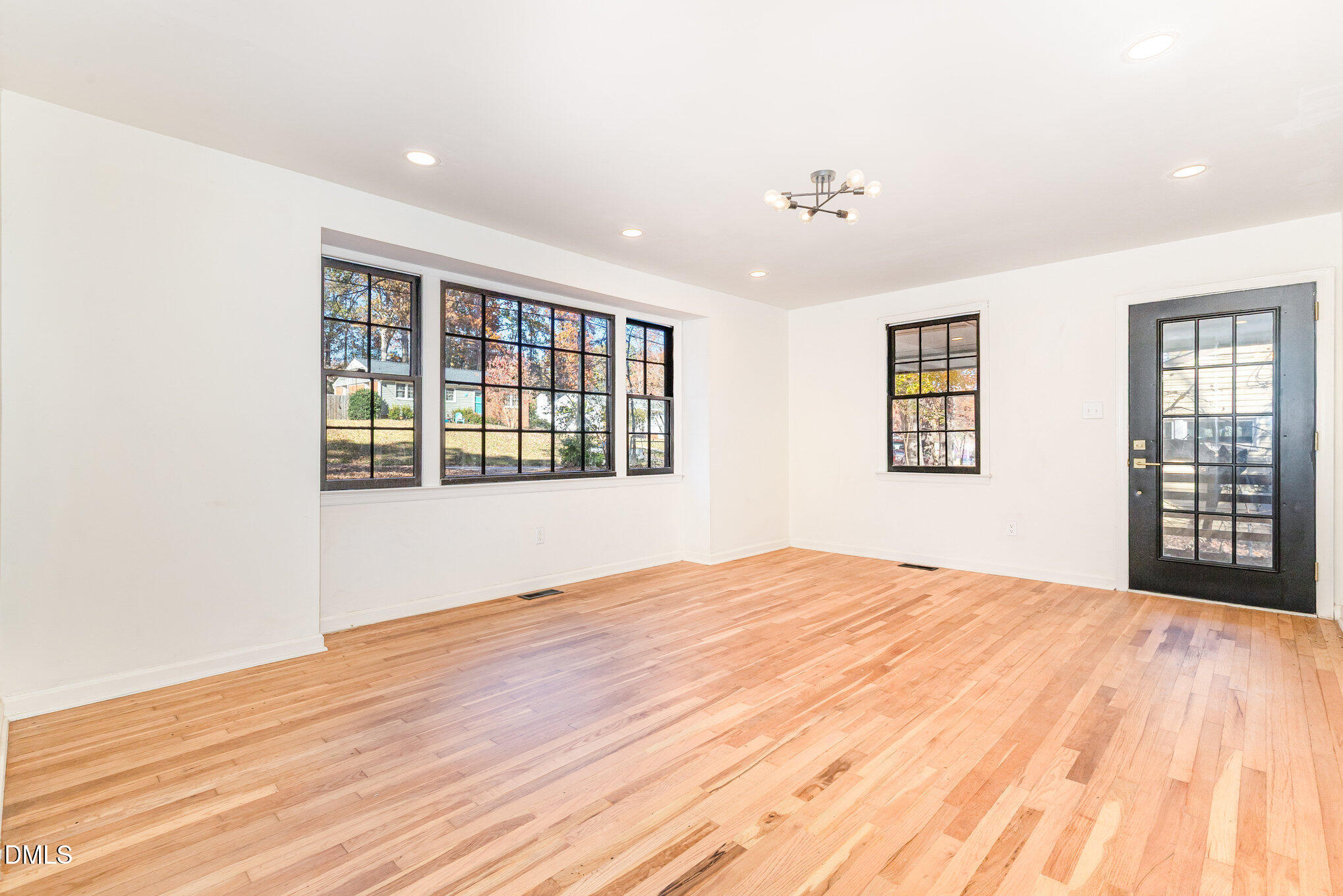 608 Dennis Avenue Raleigh, NC 27604 - Photo 8 of 30 a big room with wooden floor and windows