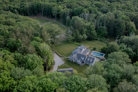 an aerial view of a house with a yard