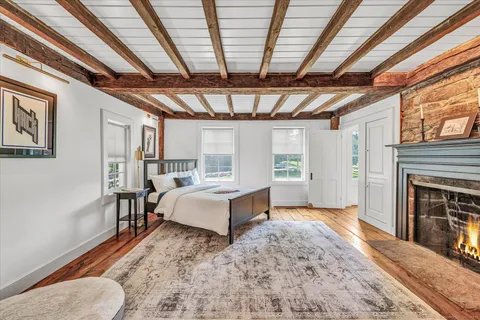 a spacious bedroom with a bed and a fireplace