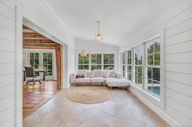 a living room with furniture and large windows