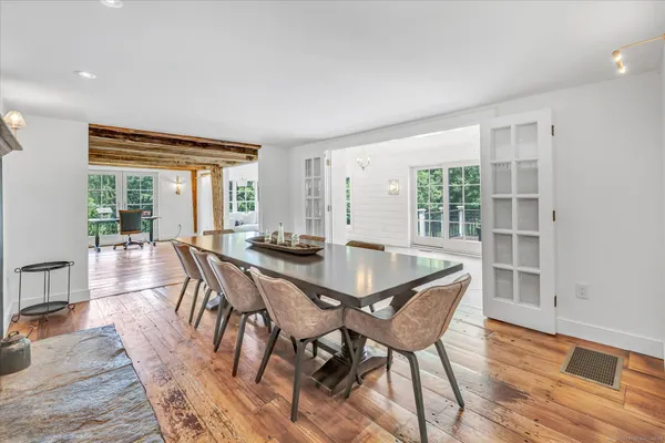 a dining room with furniture and wooden floor