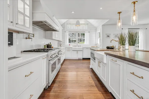 a large kitchen with stainless steel appliances lots of counter space and a sink