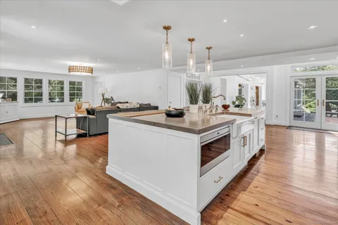 a kitchen with stainless steel appliances a stove top oven and kitchen island