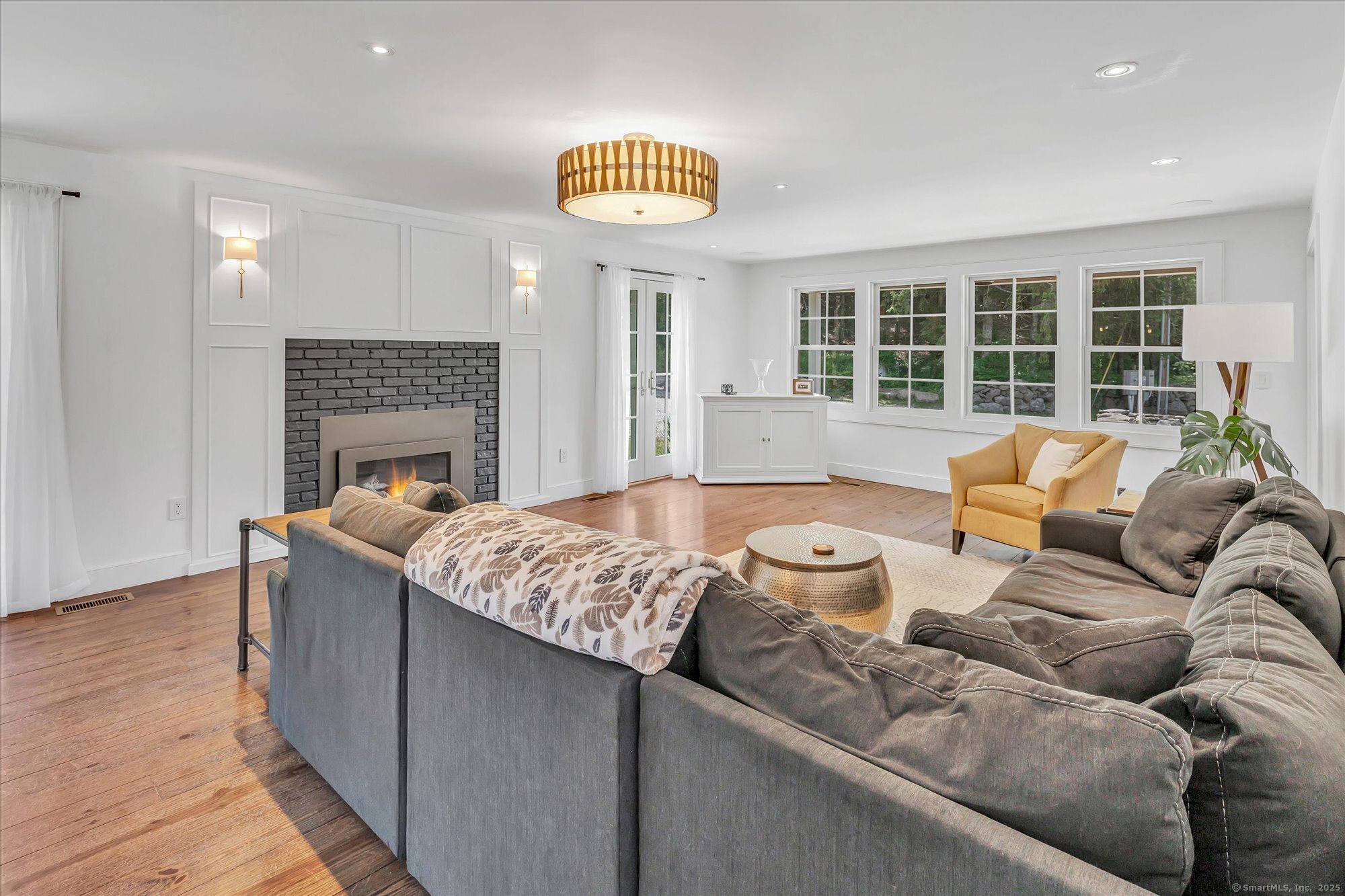 188 Wolf Neck Road Stonington, CT 06378 - Photo 26 of 40 a living room with furniture and a fireplace