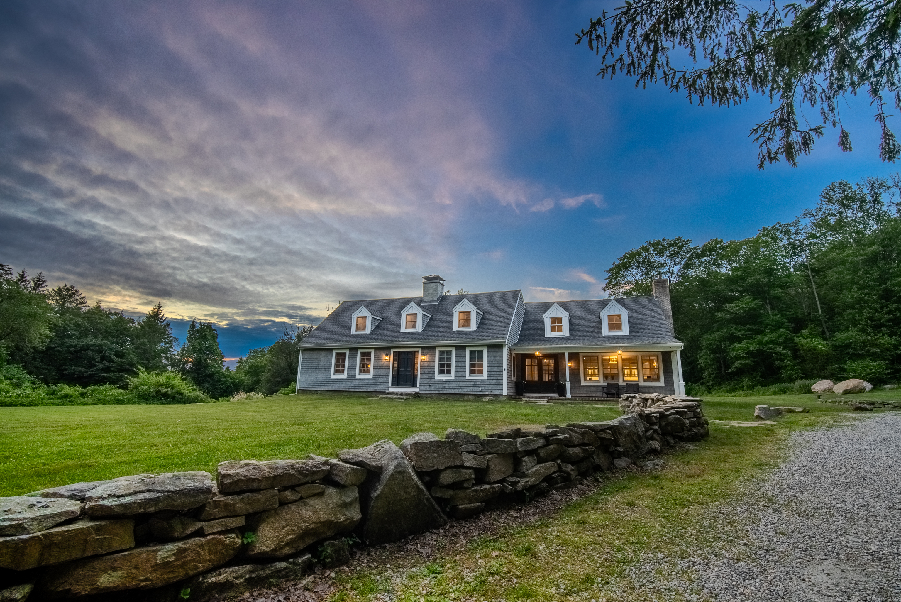 188 Wolf Neck Road Stonington, CT 06378 - Photo 3 of 40 a view of a big house with a big yard and large trees